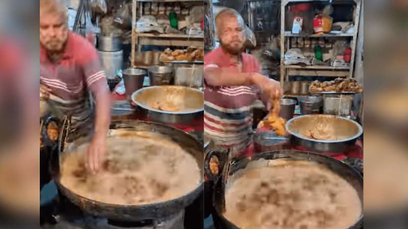 رجل يضع يده فى الزيت المغلي